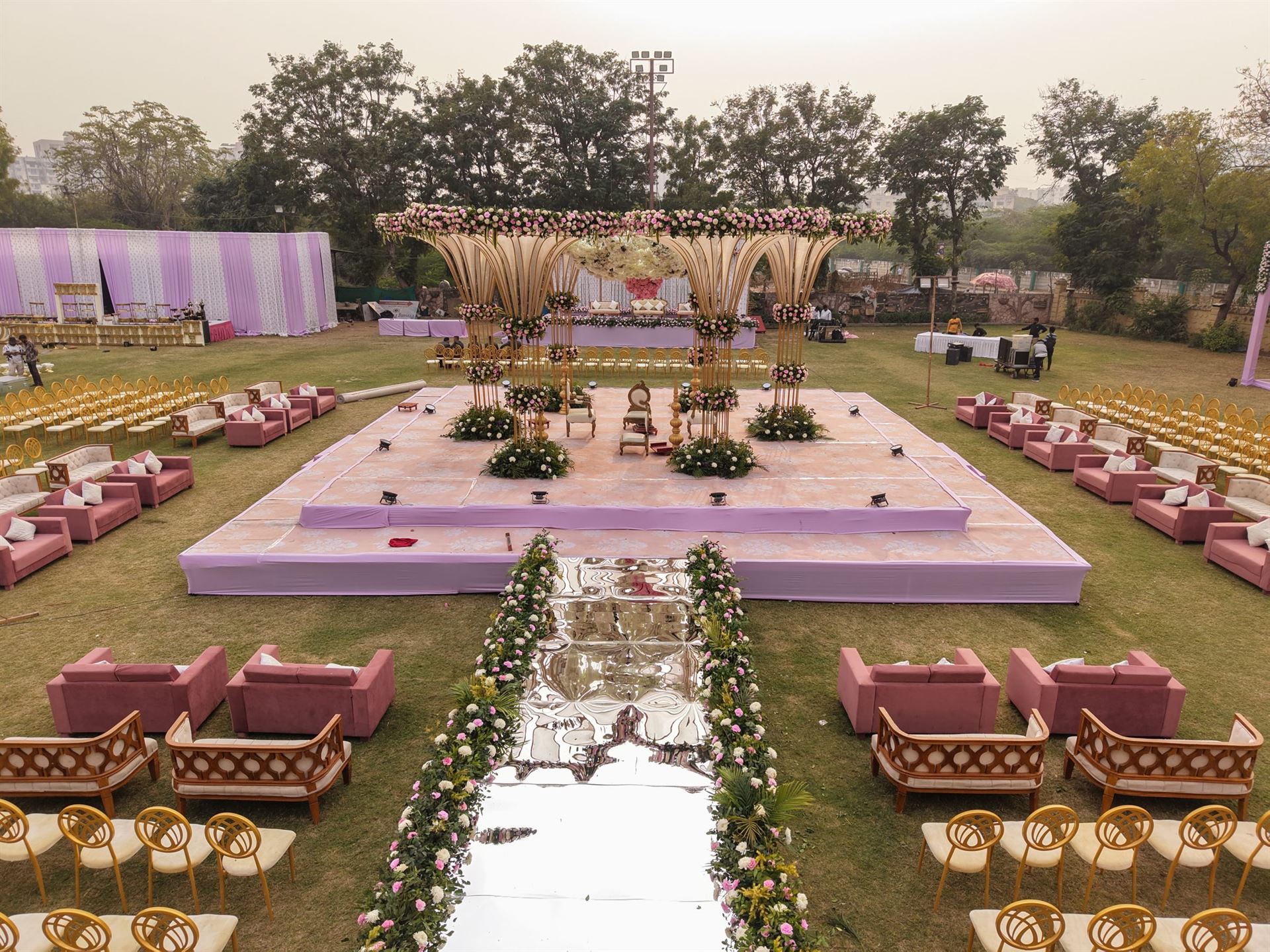 Full lawn wedding decor composition with mandap, guest seating and floral styling