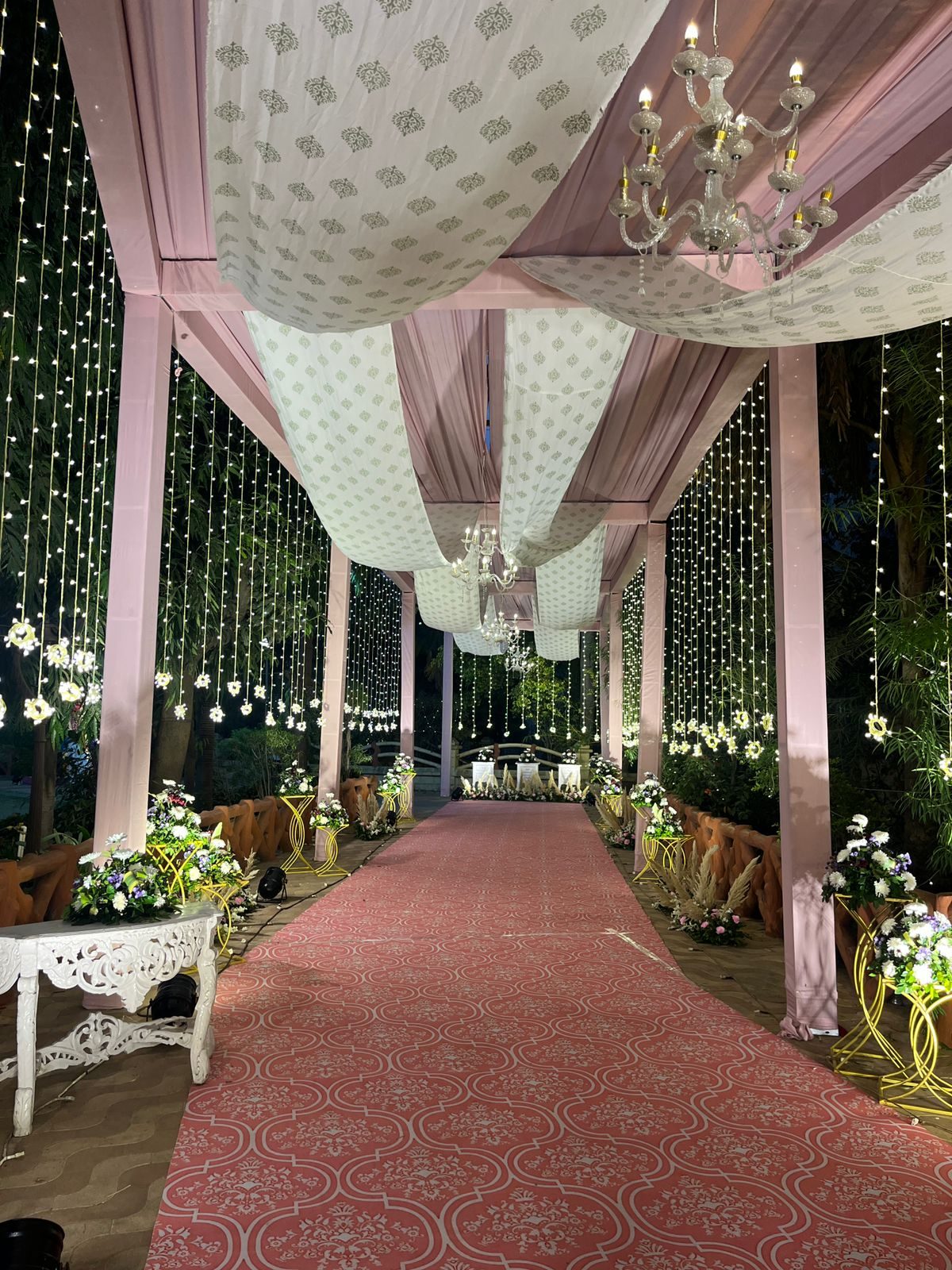 Night walkway with chandeliers and fairy lights
