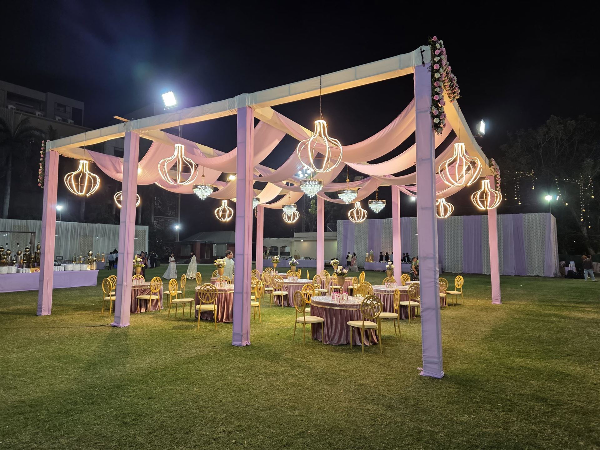 Elegant corporate gala decor with candlelit tablescapes and champagne drapery in Ahmedabad