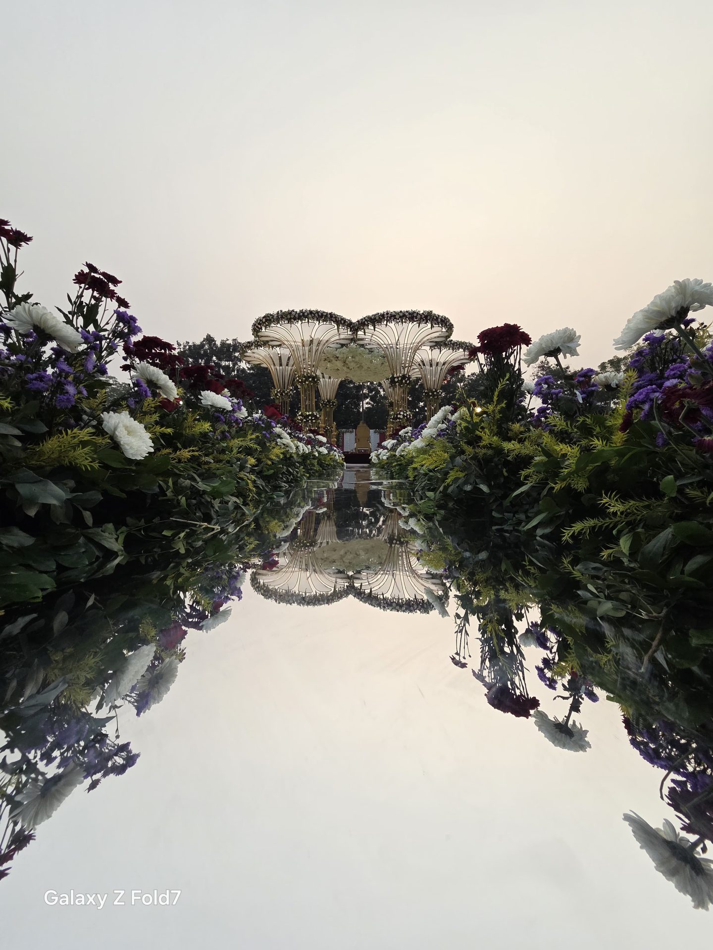 Mirror-finish wedding mandap decor reflecting floral arrangements